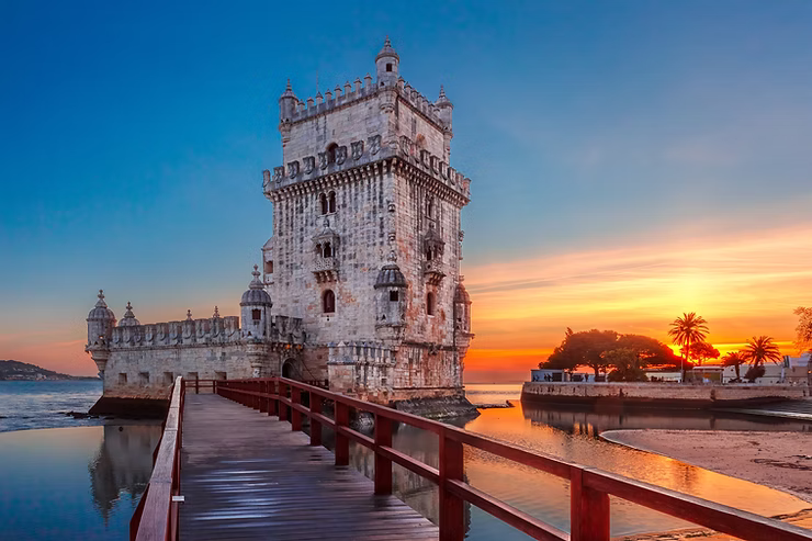 Image of Torre de Belém in Lisbon Portugal with the sun setting behind it 